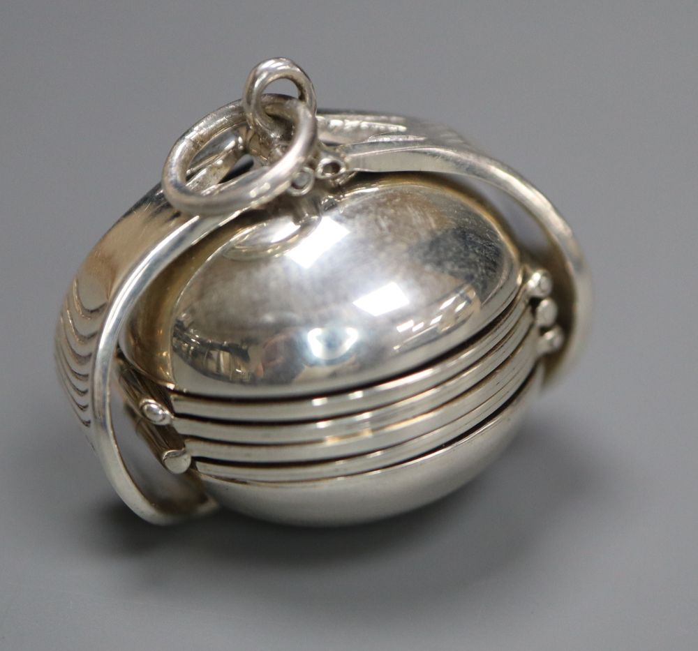A modern 925 metamorphic hinged sphere pendant, opening to reveal four miniature photograph frames, 27mm.